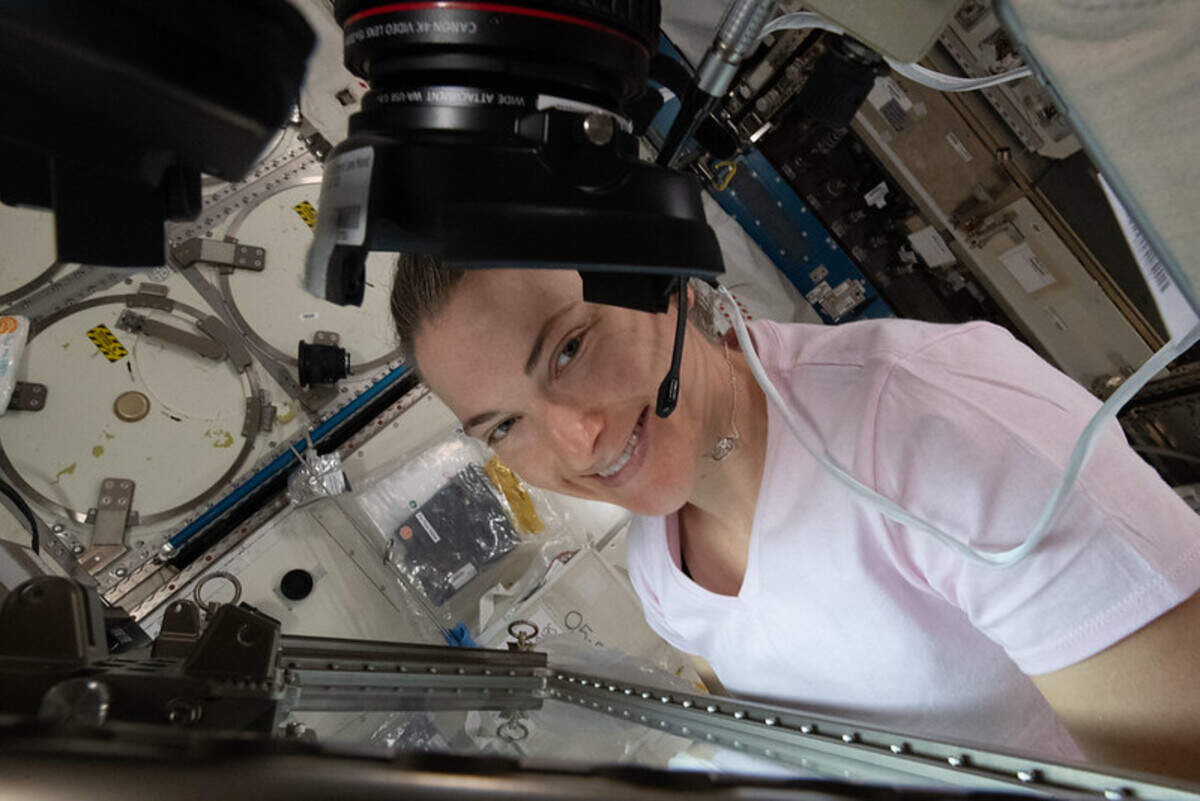 NASA astronaut Kayla Barron works inside the International Space Station’s Life Science Glovebox conducting botany research looking at the genetic architecture of plant regeneration in space in 2022.